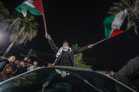 Palestinians react to news of a ceasefire agreement with Israel, in Deir al Balah, central Gaza