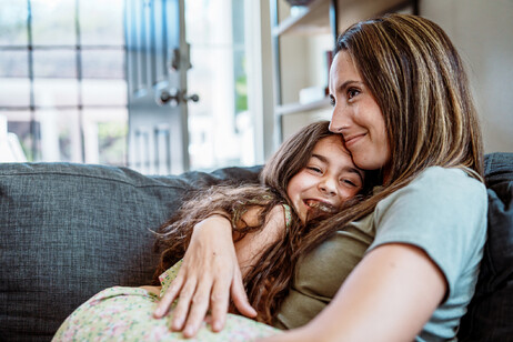 Una madre abbraccia accogliente la figlia foto iStock.