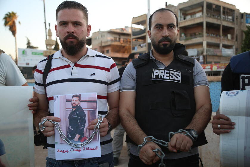 Syrian journalists protest after a colleague was arrested in northern Syria