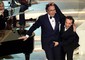 Roberto Benigni 'tocca' Pippo Baudo sul palco del teatro Ariston durante l'ultima serata del 52/o Festival della Canzone Italiana, vinto dai Matia Bazar nel 2002 con il brano 'Messaggio d' amore' © Ansa